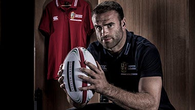 British and Irish Lions rugby player Jamie Roberts holds up rugby ball 