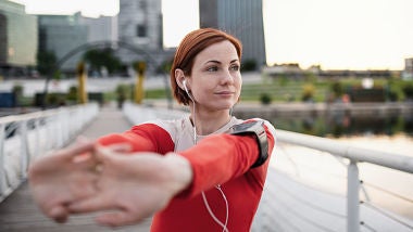 woman jogging on bridge